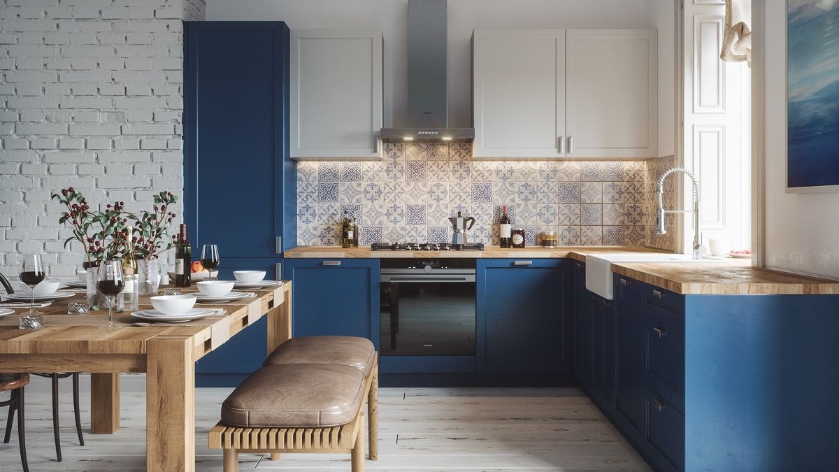 Hệ tủ bếp gỗ nhân tạo với tone màu trắng xanh chủ đạo làm nổi bật căn bếp, sử dụng cửa sổ giúp thoáng khí và hút ánh sáng tự nhiên