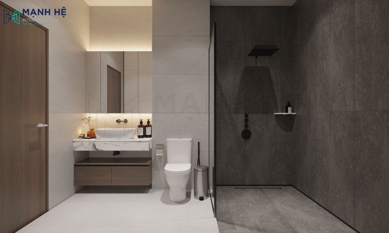 Khu vực tắm được ngăn cách với khu vực vệ sinh bằng cánh kính và ốp đá màu tối hơn khu vực ngoài