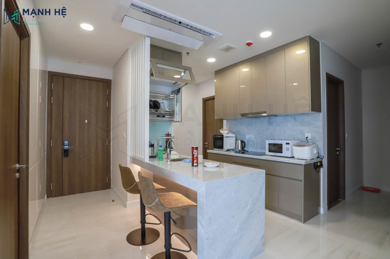 Thi công bàn đảo bếp sang trọng, nổi bật với hệ đèn led phản chiếu với bề mặt ốp Acrylic lung linh phía trước bàn đảo bếp