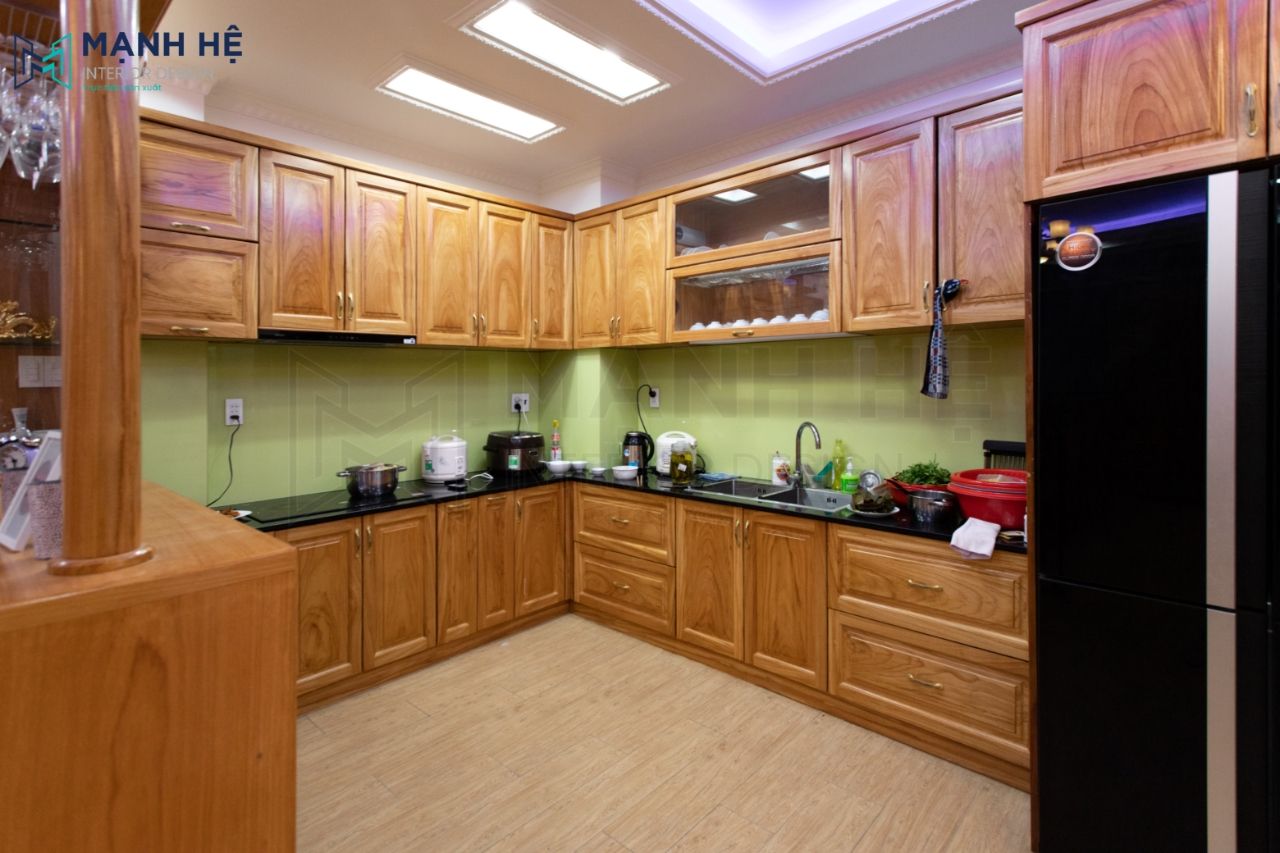 Tủ bếp với kính ốp xanh vừa tạo điểm nhấn vừa giúp cho gia chủ dễ dàng lau chùi sau khi nấu ăn