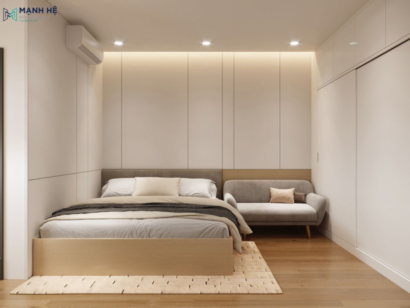 Giường và ghế sofa bọc vải đặt cạnh nhau linh hoạt cho việc nghỉ ngơi, thư giãn kết hợp tủ quần áo âm tường, cửa lùa tối ưu diện tích phòng ngủ