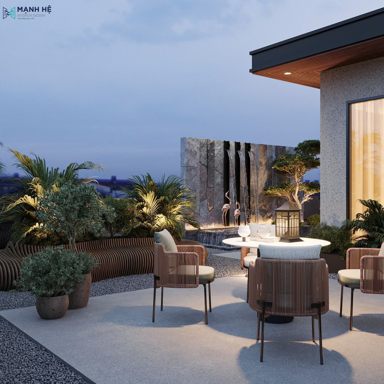 Không gian bàn tròn 4 ghế đặt cạnh thác nước, được bao quanh bởi cây xanh tạo cảm giác yên tĩnh và gần gũi thiên nhiên