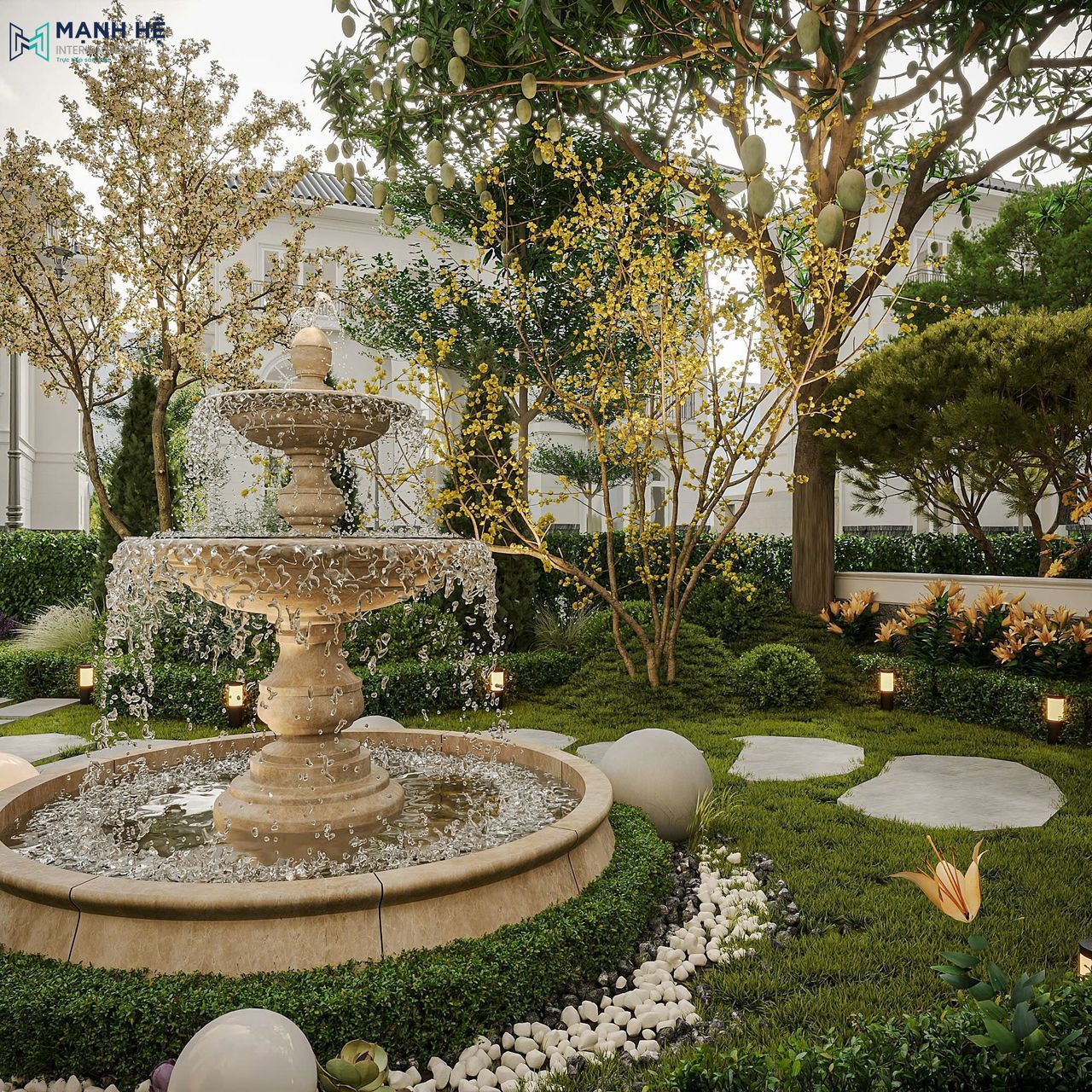 Đài phun nước đá tự nhiên giữa sân vườn biệt thự, bao quanh bởi cây xanh và lối đi lát đá