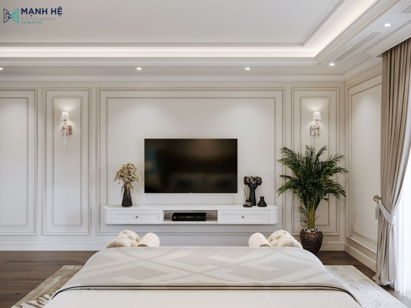 Hệ tủ tivi treo tường thiết kế tối giản, kết hợp đường phào chỉ nổi bật, đèn tường đối xứng và trang trí bằng cây xanh