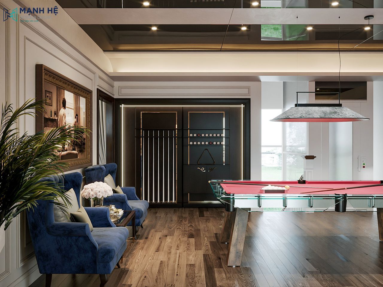 Góc thư giãn trong sảnh tầng với cặp ghế bọc nhung xanh navy, bàn trà mặt kính và ánh sáng vàng từ đèn trần mang lại cảm giác ấm cúng