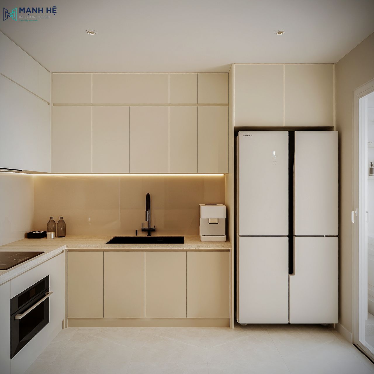 Khu bếp chữ L hiện đại với hệ tủ trên – dưới đồng bộ màu kem, bếp từ và lò nướng âm tường.