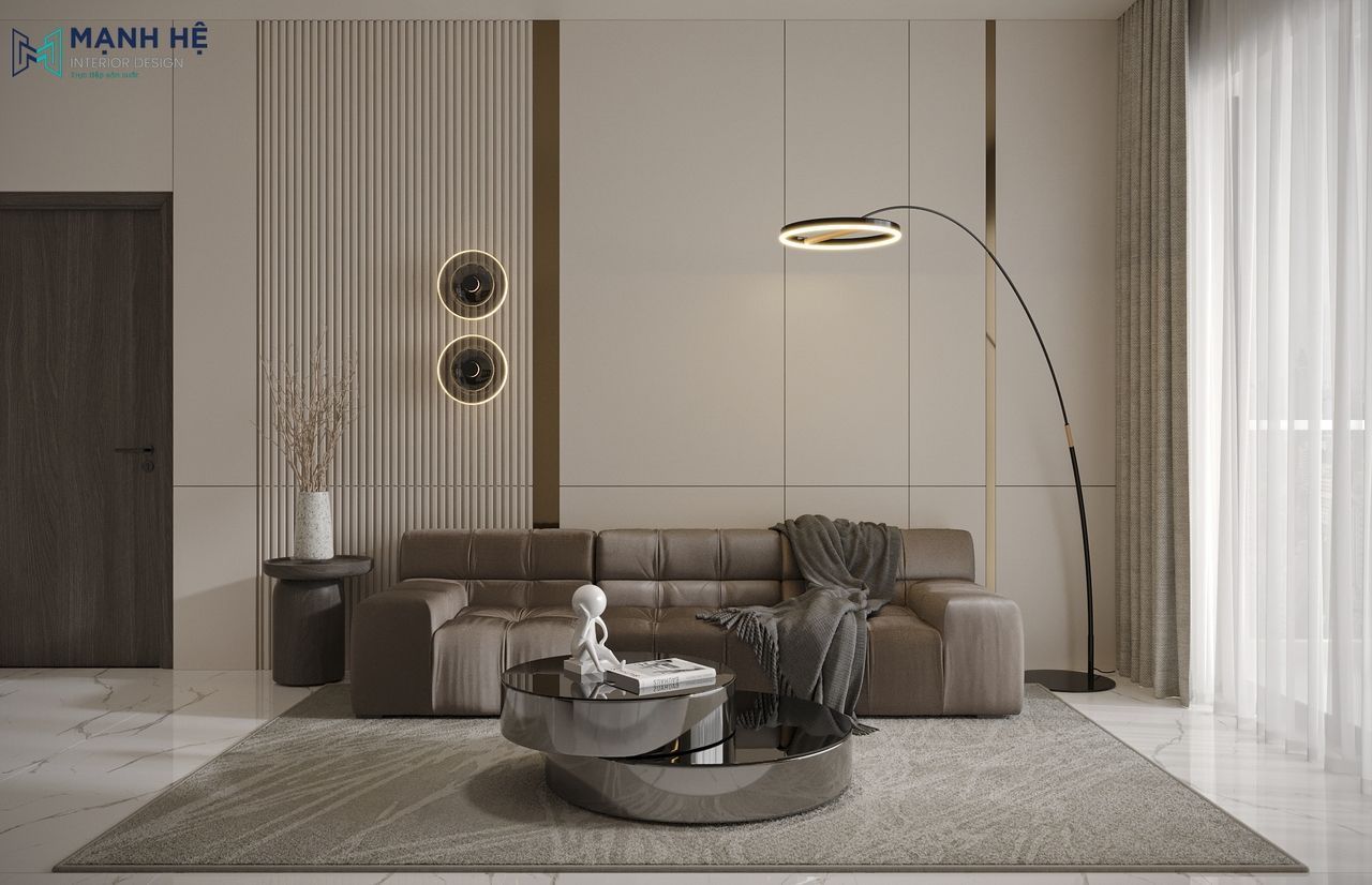 Không gian phòng khách chung cư sử dụng gam màu xám chủ đạo làm nền cho chiếc ghế sofa nâu ấm cúng kết hợp bàn trà đôi màu đen