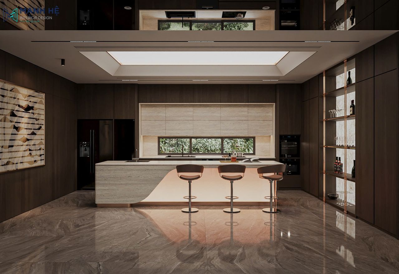 Toàn cảnh phòng bếp hiện đại với đảo bếp đá, hệ tủ gỗ và ánh sáng gián tiếp